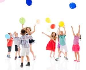 Group of happy children  having fun while jumping with balloons. Isolated on white.